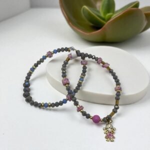 Set de pulseras cristales con dije de una niña en baño de oro de 14K